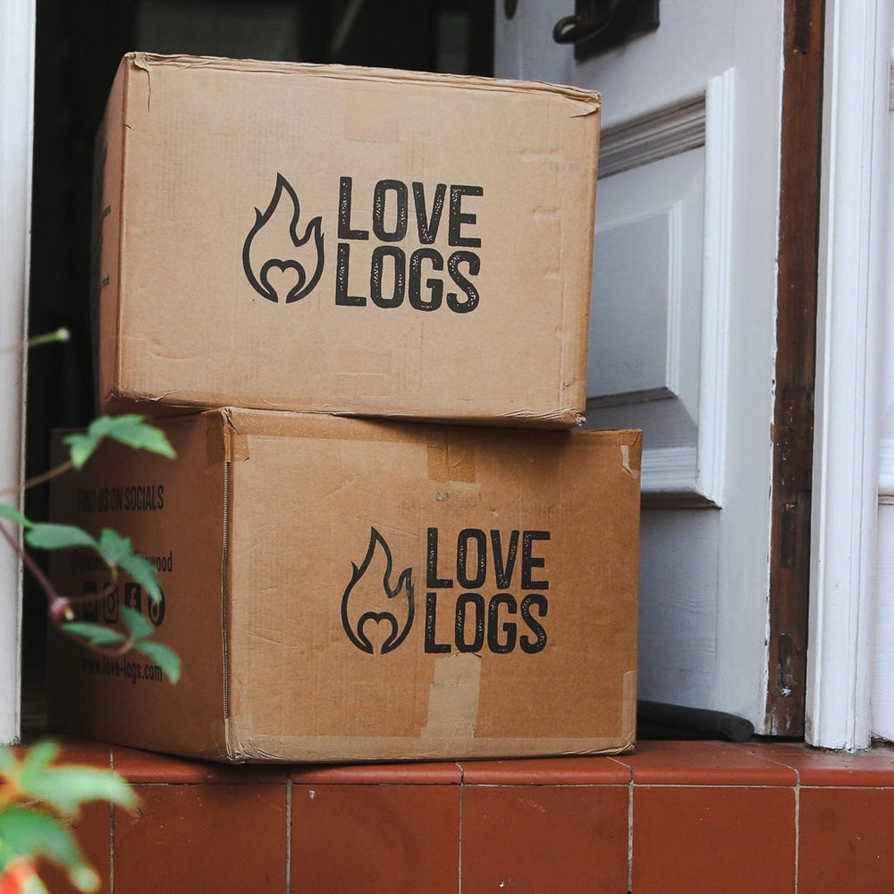 Love Logs cardboard boxes on a doorstep