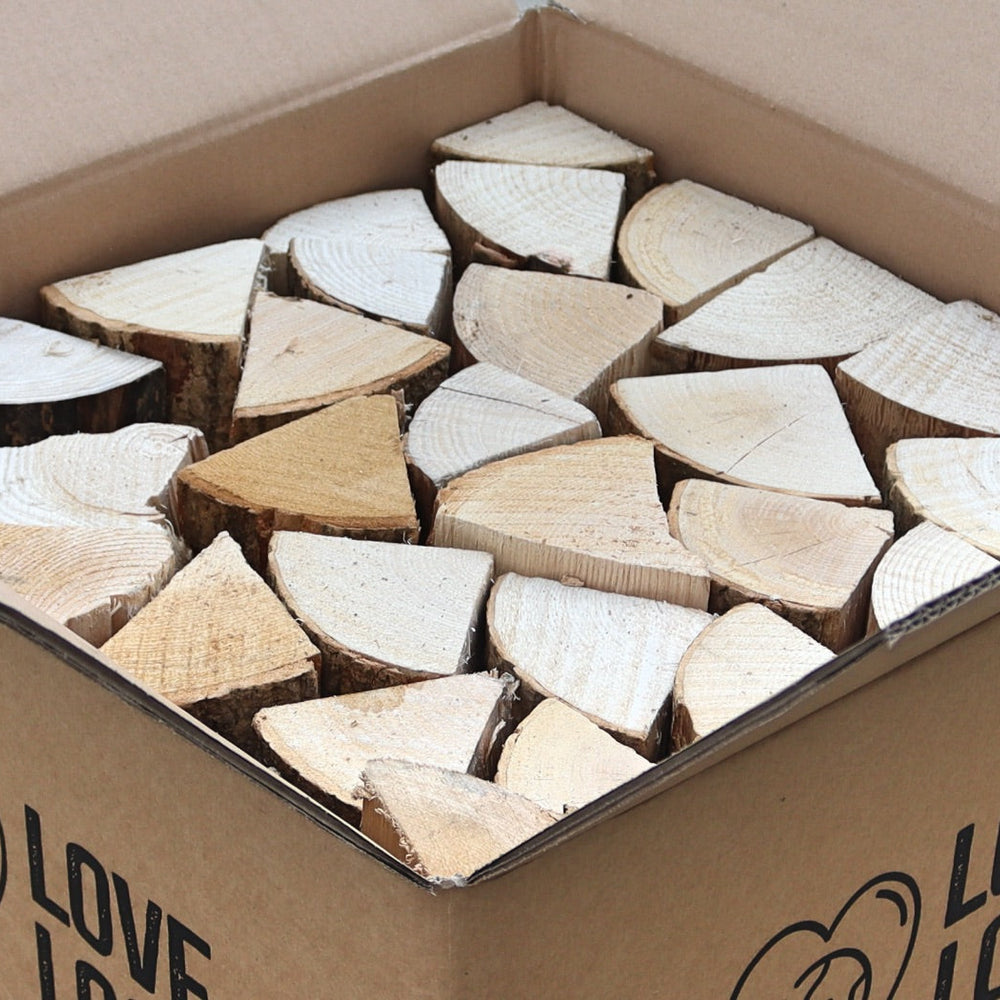 A Love Logs cardboard box containing hardwood logs