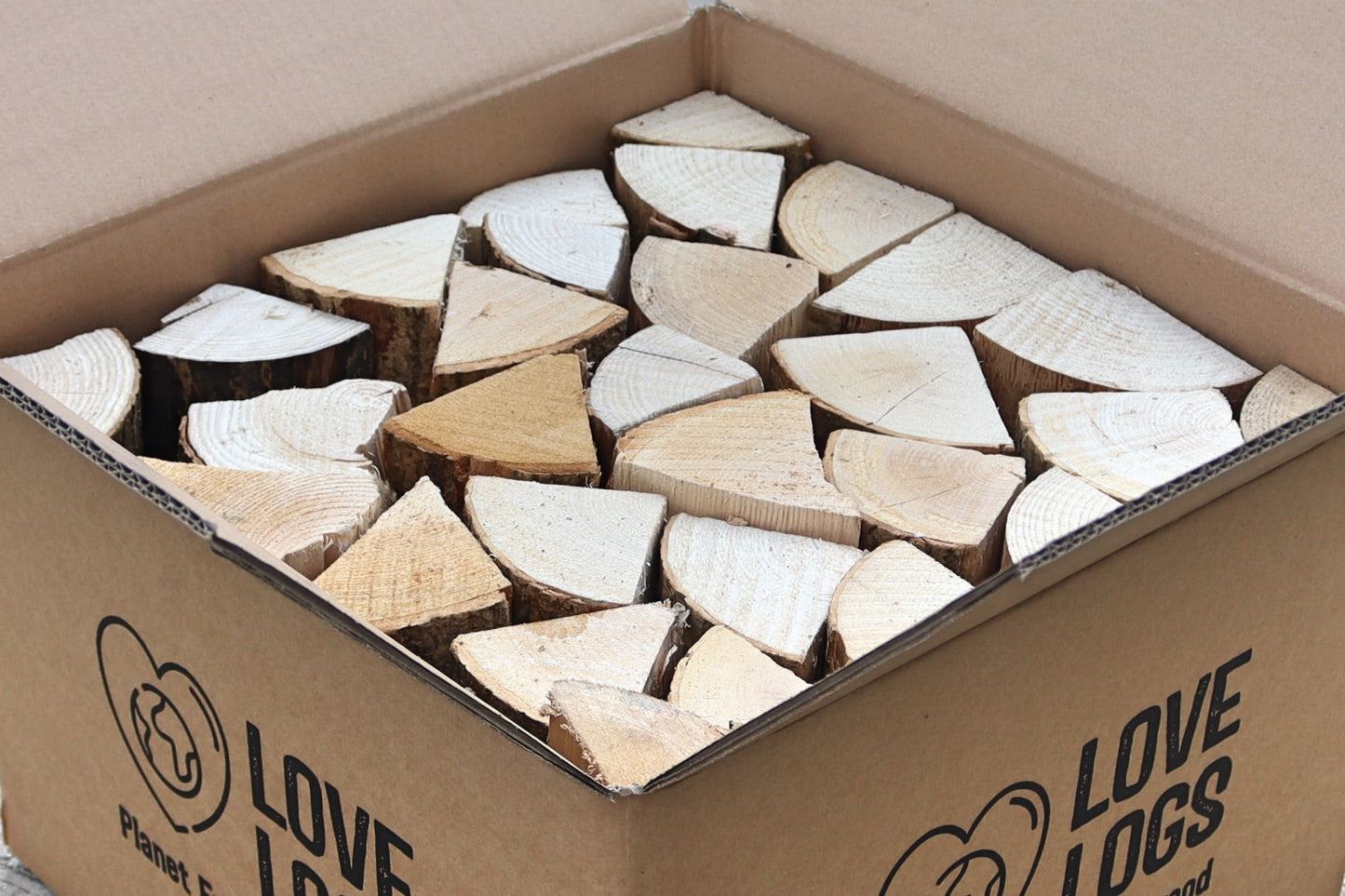 A Love Logs cardboard box containing hardwood logs