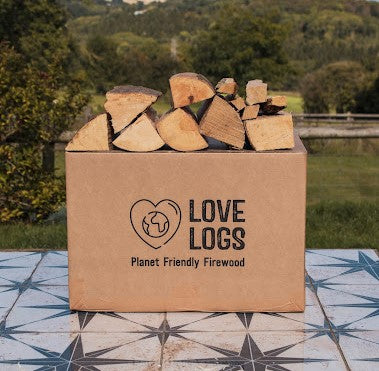 Firewood in a Love Logs cardboard box