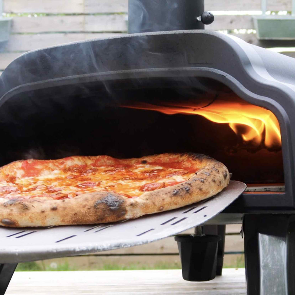 A wood fired Neapolitan Margherita pizza baked in the Thord pizza oven, also shown